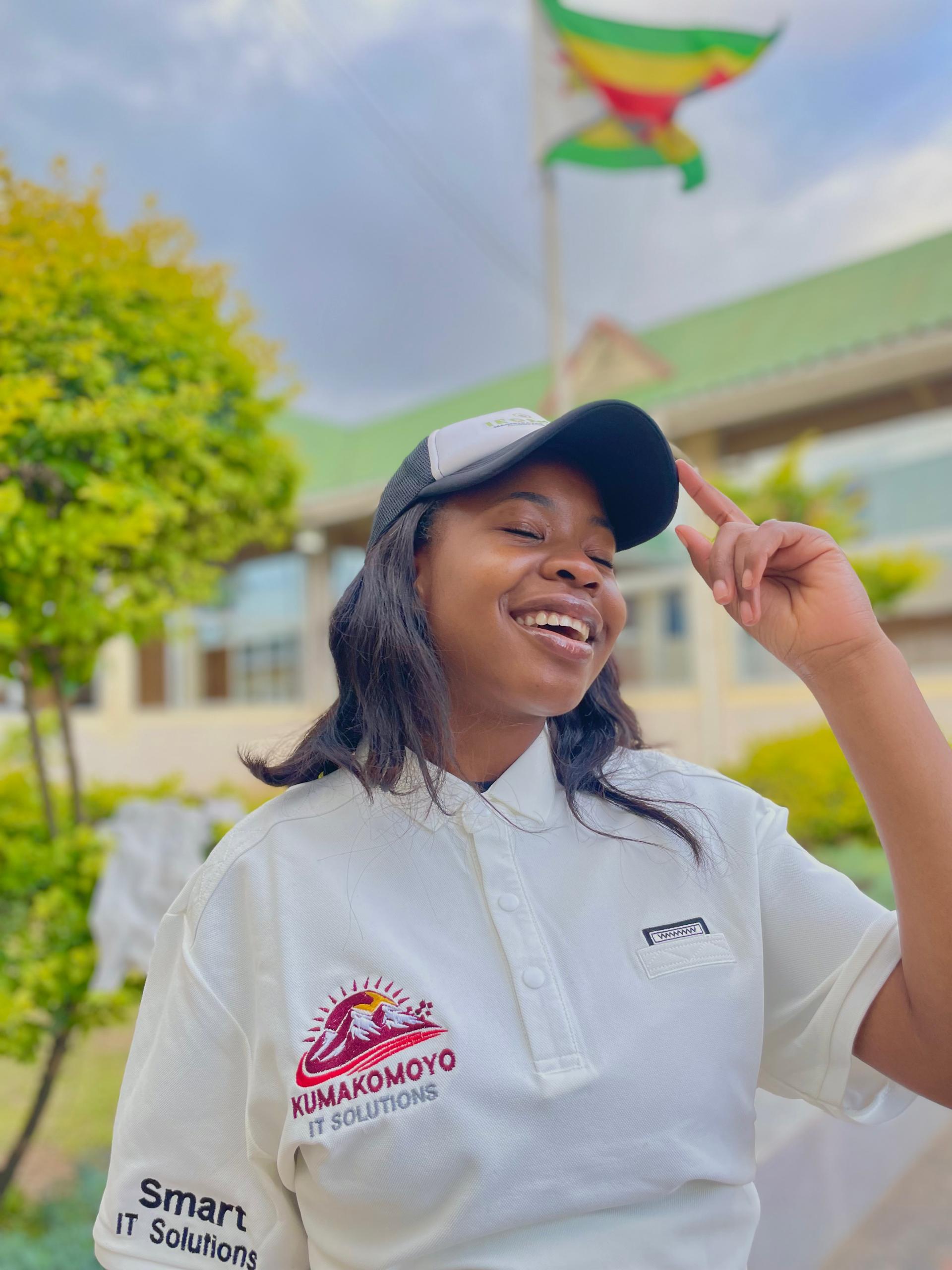 Customer wearing a Kumakomoyo IT Solutions branded cap and polo shirt